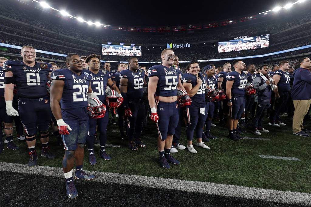 Navy listens to Army alma mater after an NCAA college football game Saturday, Dec. 11, 2021, in East Rutherford, N.J. Navy won 17-13. (AP Photo/Adam Hunger)