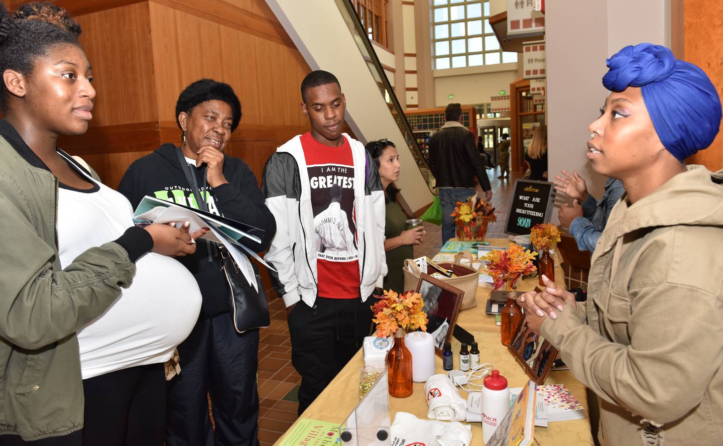 Dominique Hunter, the Military Breastfeeding Network active duty director, explains doula and breastfeeding options to new moms at a Womack Army Medical Center maternity fair at Fort Liberty, North Carolina, in 2018.